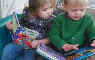 Two toddlers reading