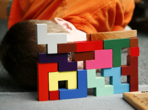boy looking through montessori blocks colorful creative success