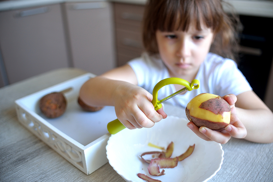 https://www.montessoricenter.org/wp-content/uploads/2021/07/bigstock-Child-Peels-Potatoes-With-A-Gr-412791838.jpeg