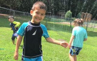 children playing in sprinkler