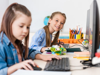 two girls working on computer and robotics