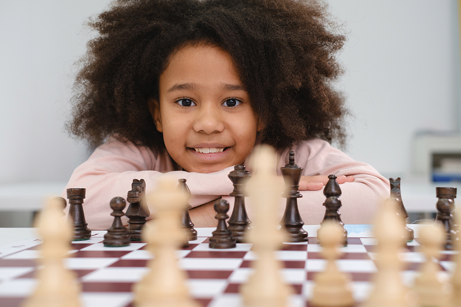 Young girl playing chess