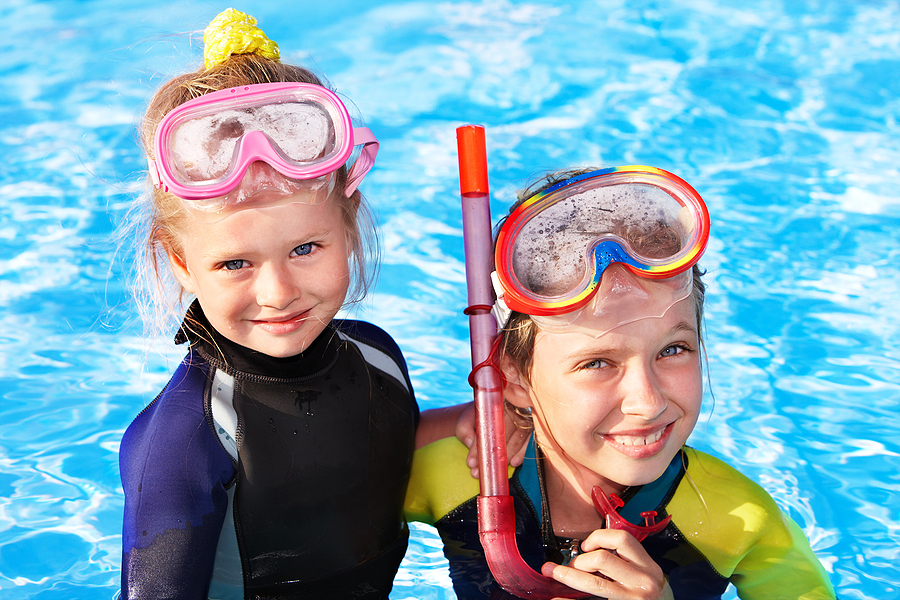 children snorkeling in swimming pool