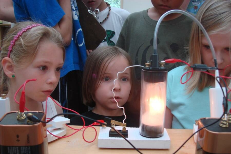 Children looking at electricity science experiment