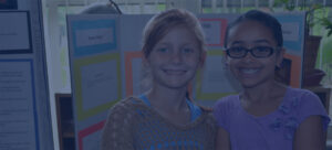 two girls presenting at science fair