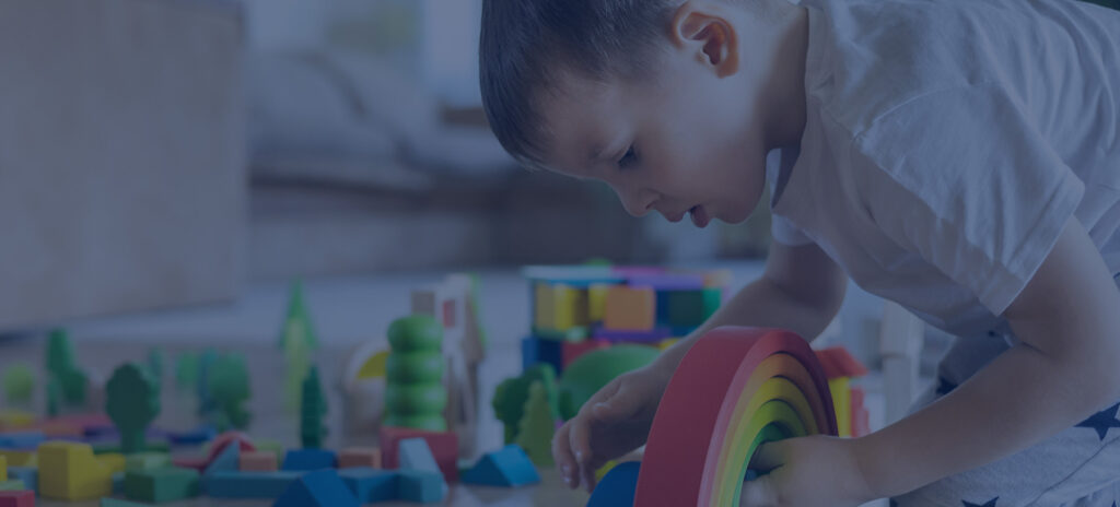 boy playing with Montessori Materials