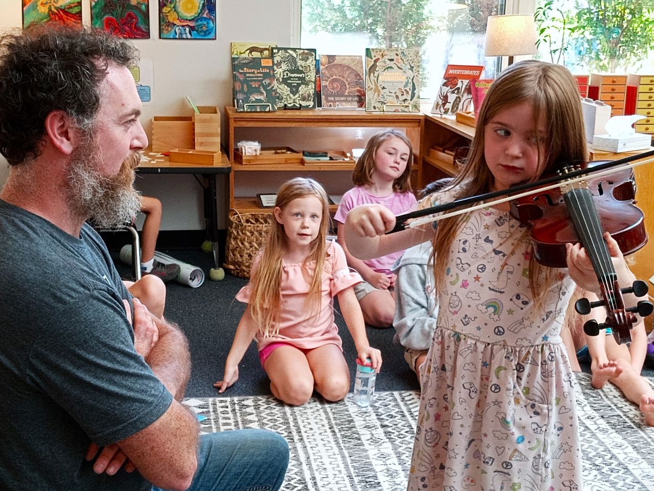 child with teacher playing the violin