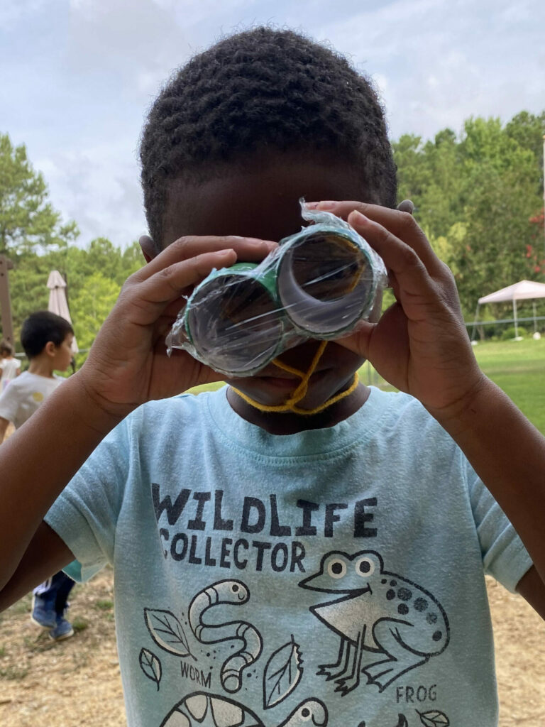 child looking through binoculars