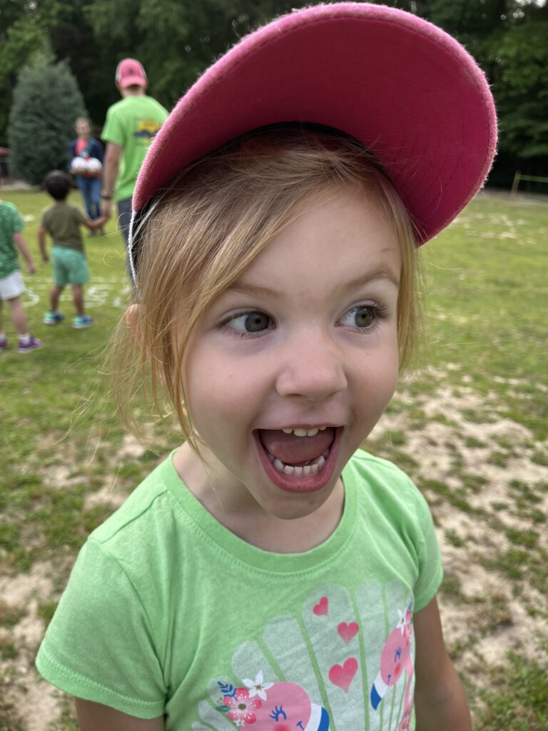 girl with a pink hat having fun outdoors