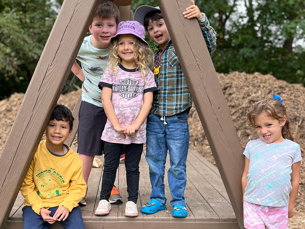 young children on a zip line platform