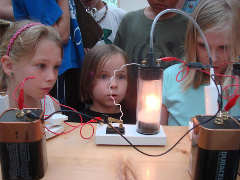 students staring at electricity kit