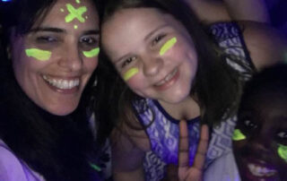 teacher and students with glow paint at The New School's student dance