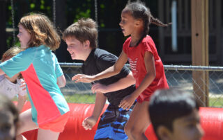 elementary aged children playing at field day at The New School