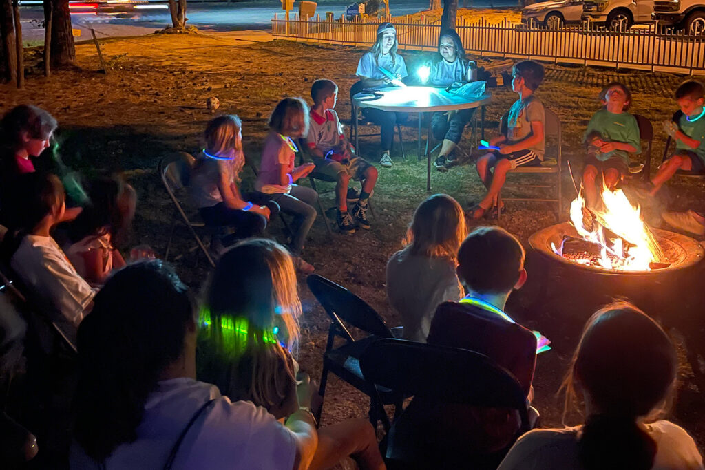 children around a campfire with teachers on a science night out event