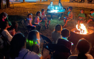 children around a campfire with teachers on a science night out event