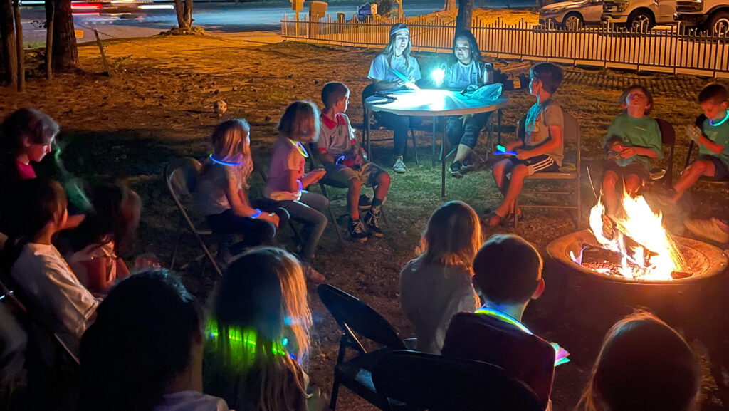 children around a campfire with teachers on a science night out event