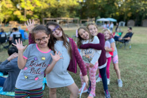 group of girls lined up posing for camera before competing in a school talent show