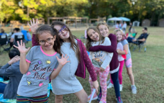 group of girls lined up posing for camera before competing in a school talent show