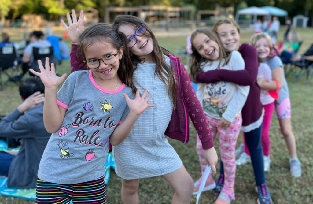 group of girls lined up posing for camera before competing in a school talent show
