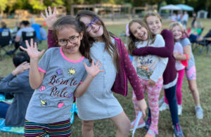 group of girls lined up posing for camera before competing in a school talent show