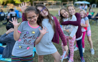 group of girls lined up posing for camera before competing in a school talent show