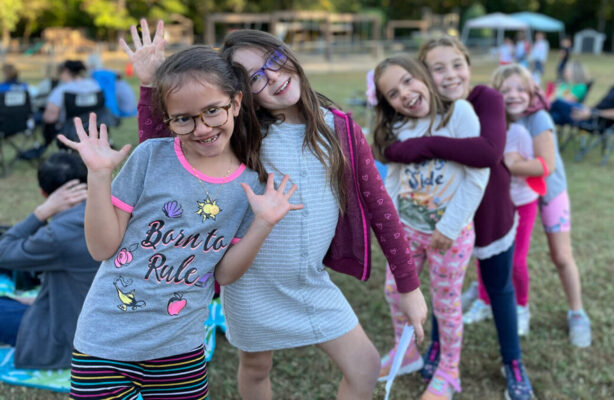 group of girls lined up posing for camera before competing in a school talent show
