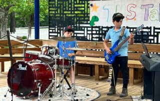 Two boys playing instruments to perform in The New School Talend show