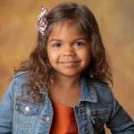 a girl smiling for school photos