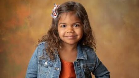 a girl smiling for school photos